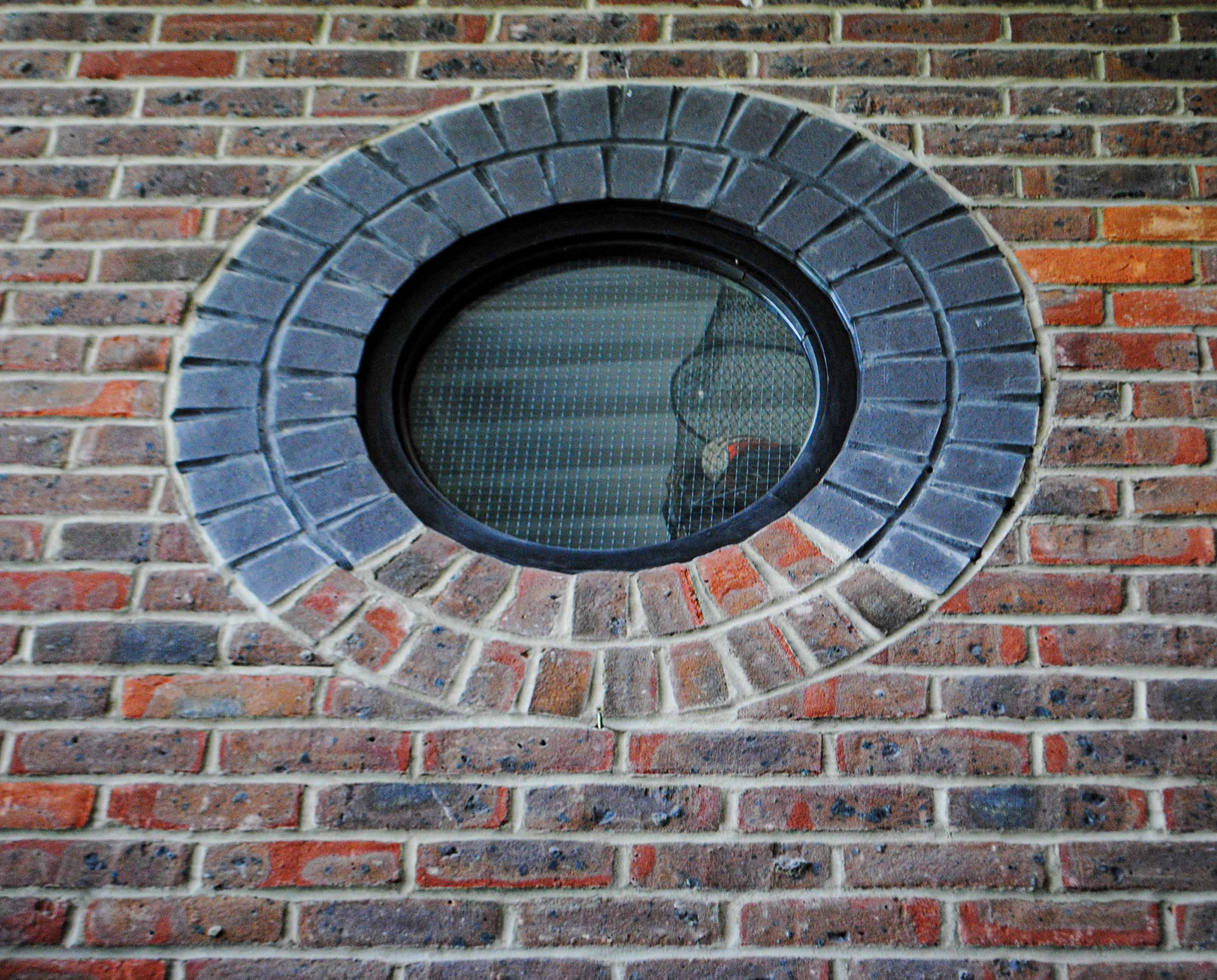 circular brick window detail with contrasting brick colours