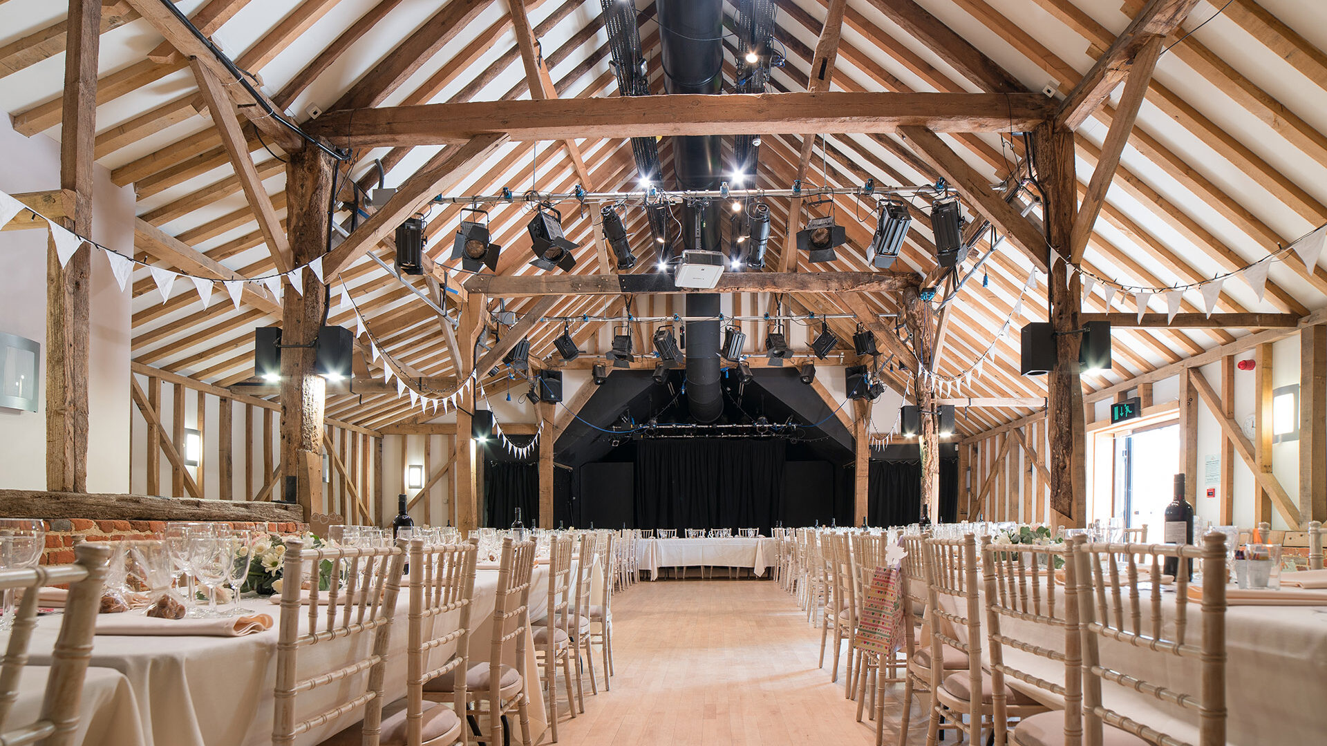 Barn set up for a wedding with exposed beams