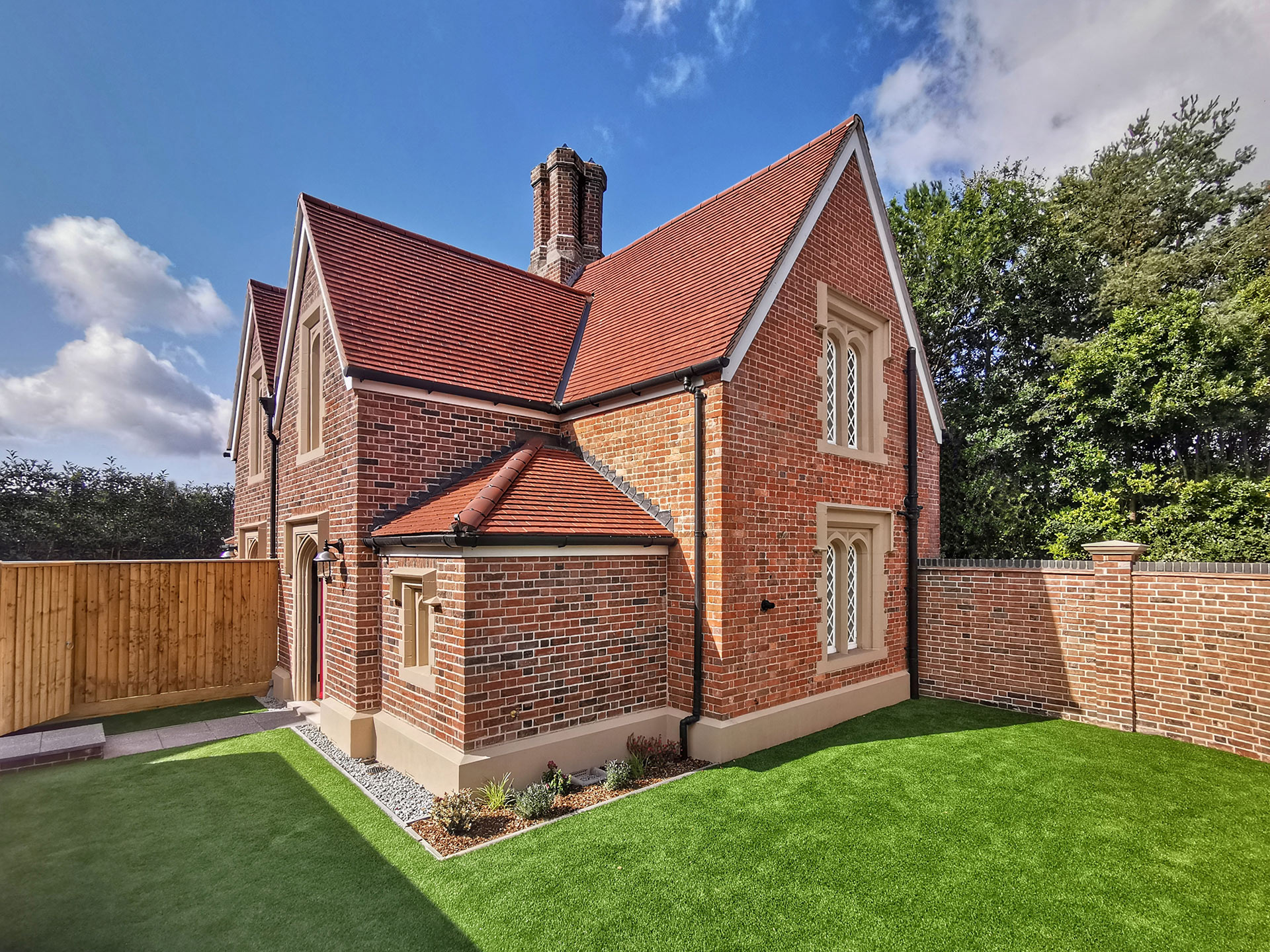 side view of red brick house with enclosed lawn garden