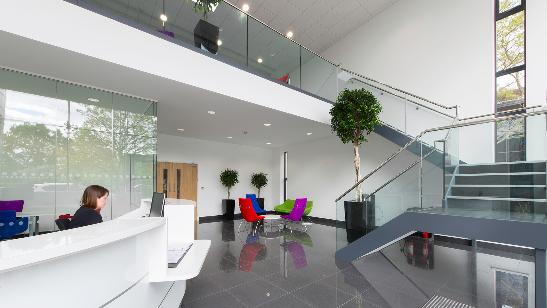 reception area with dog leg staircase leading to mezzanine floor