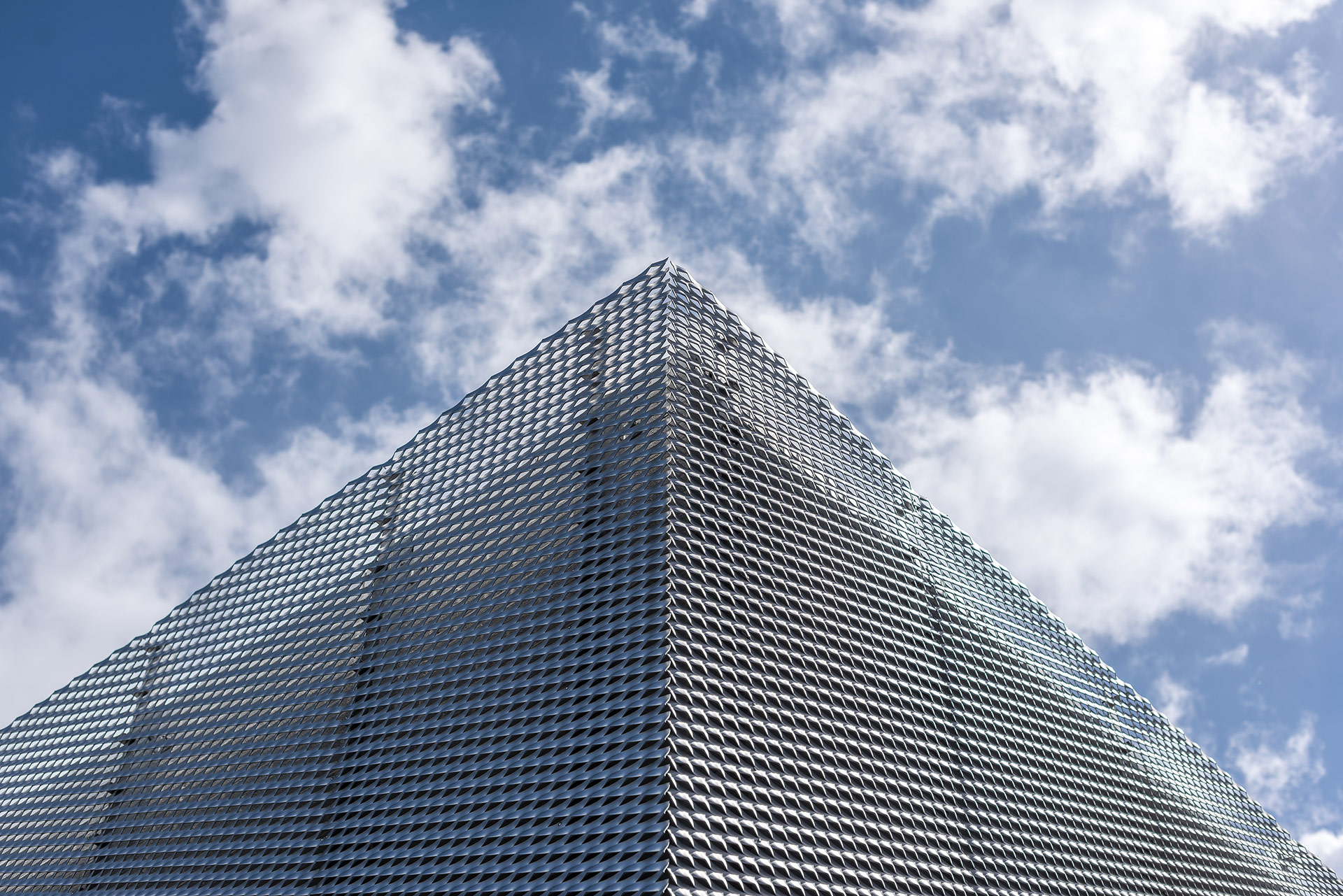 detail corner of building clad with curved-profile vertical aluminium fins