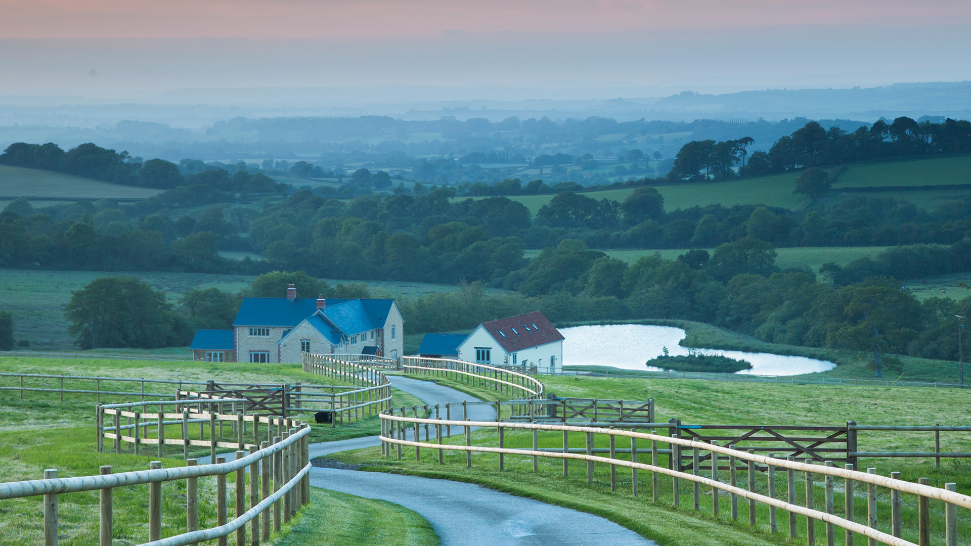 Beautiful long driveway to new farm house with stunning rolling countryside views and large pond behind house