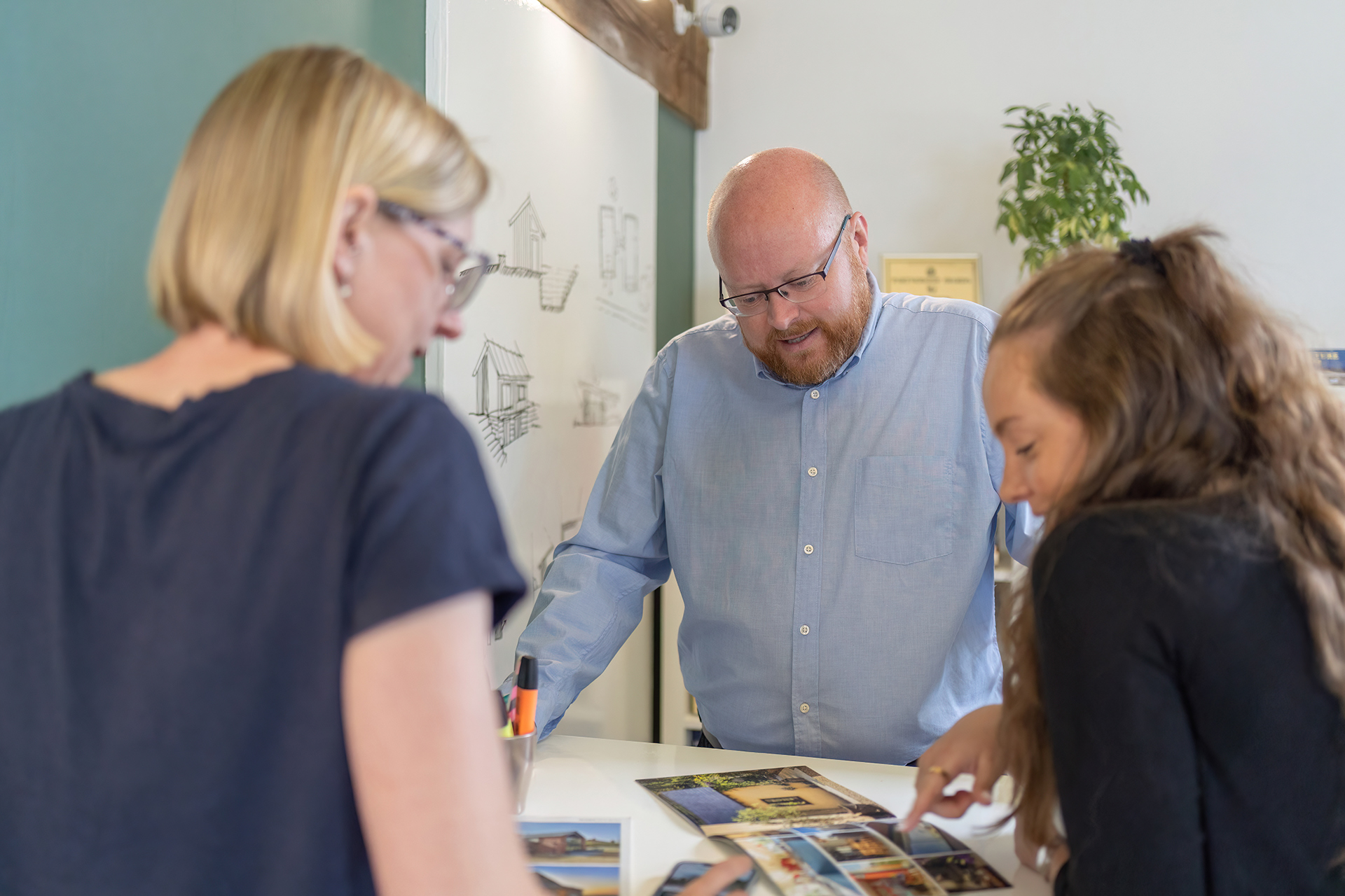 Three people discussing some images