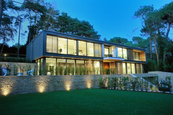 Modern house lit up at dusk