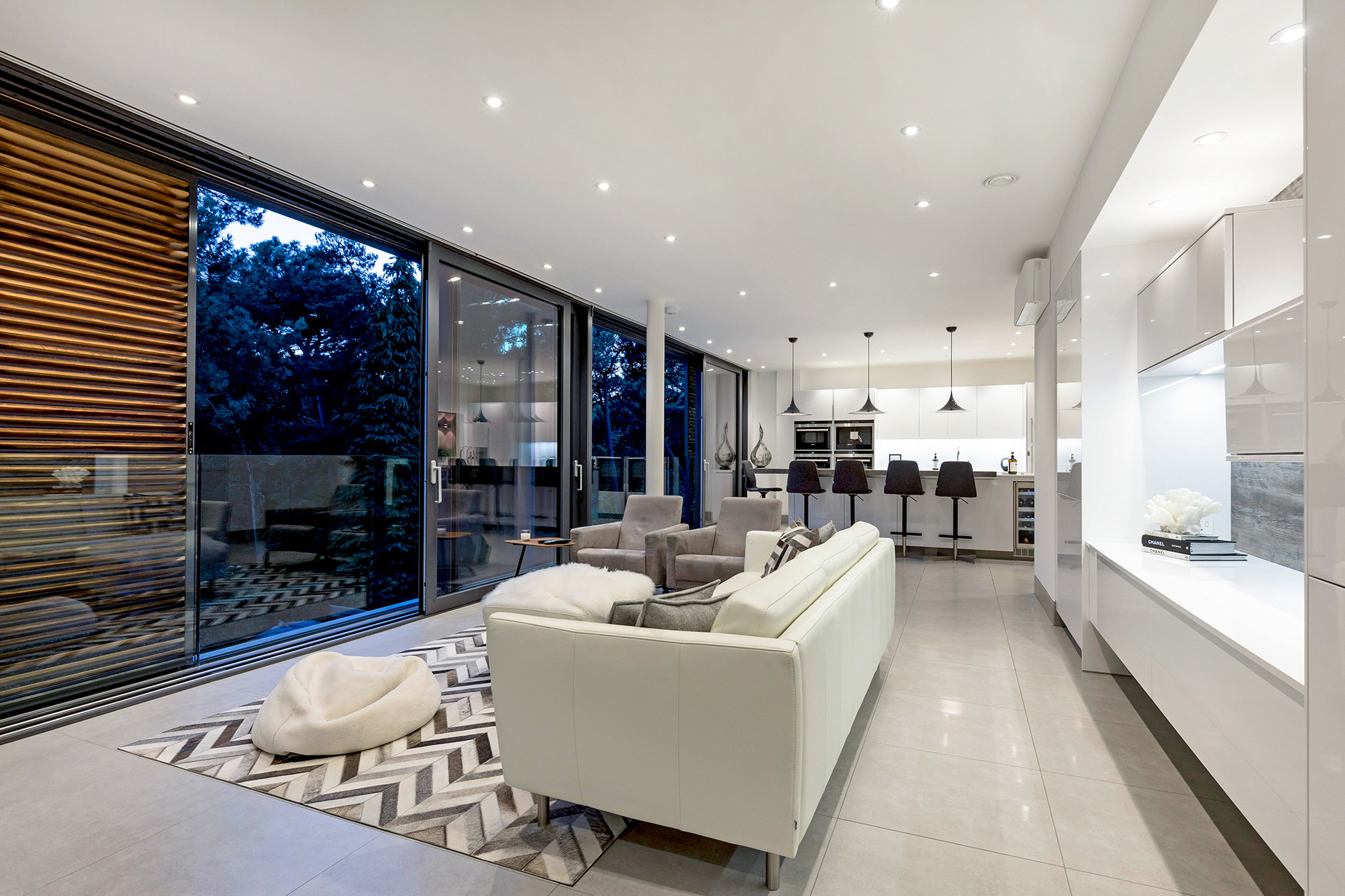 Open plan living area/kitchen with tree views