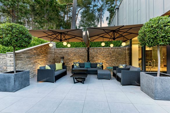 Outdoor living area, garden furniture underneath large parasol