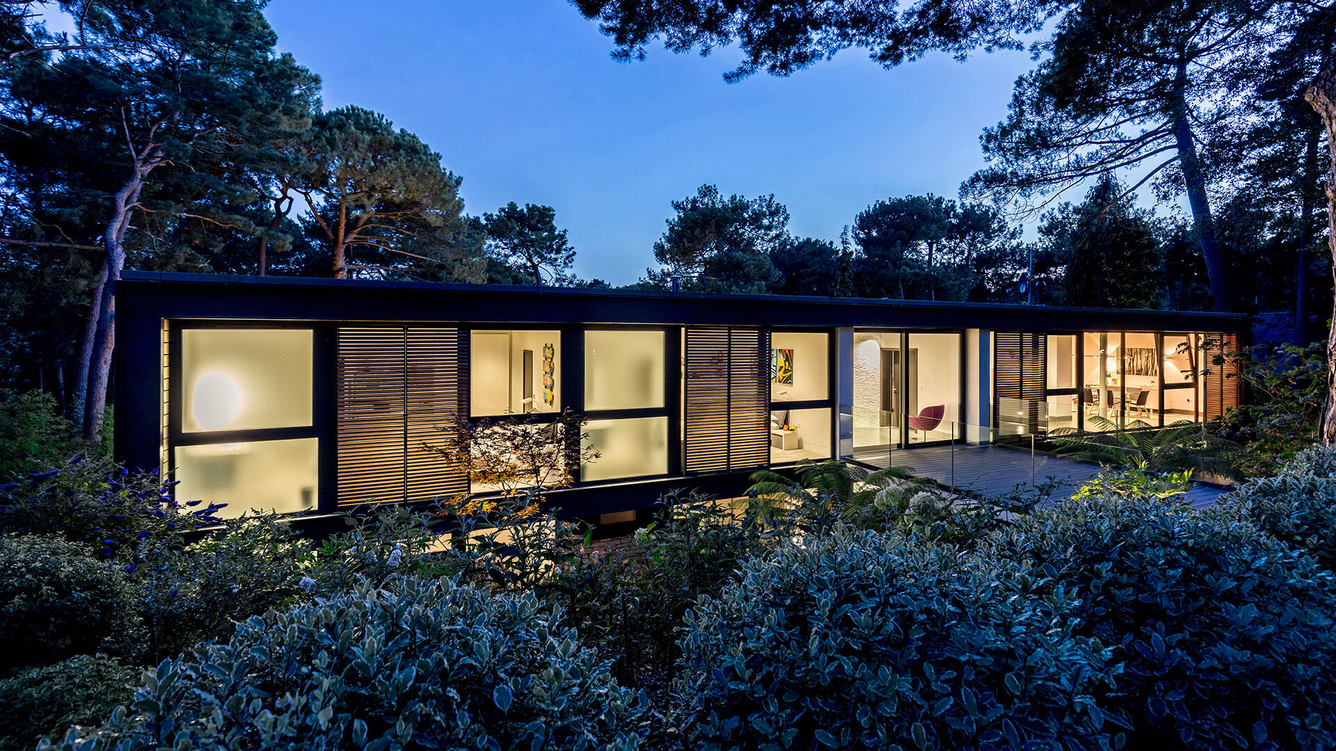 contemporary woodland house at dusk