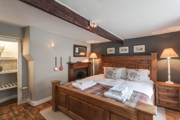 Bedroom with wooden beam. Wooden double bed.