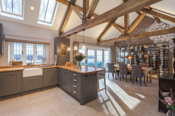 beautiful interior of a cottage kitchen diner with exposed roof trusses and stylish kitchen