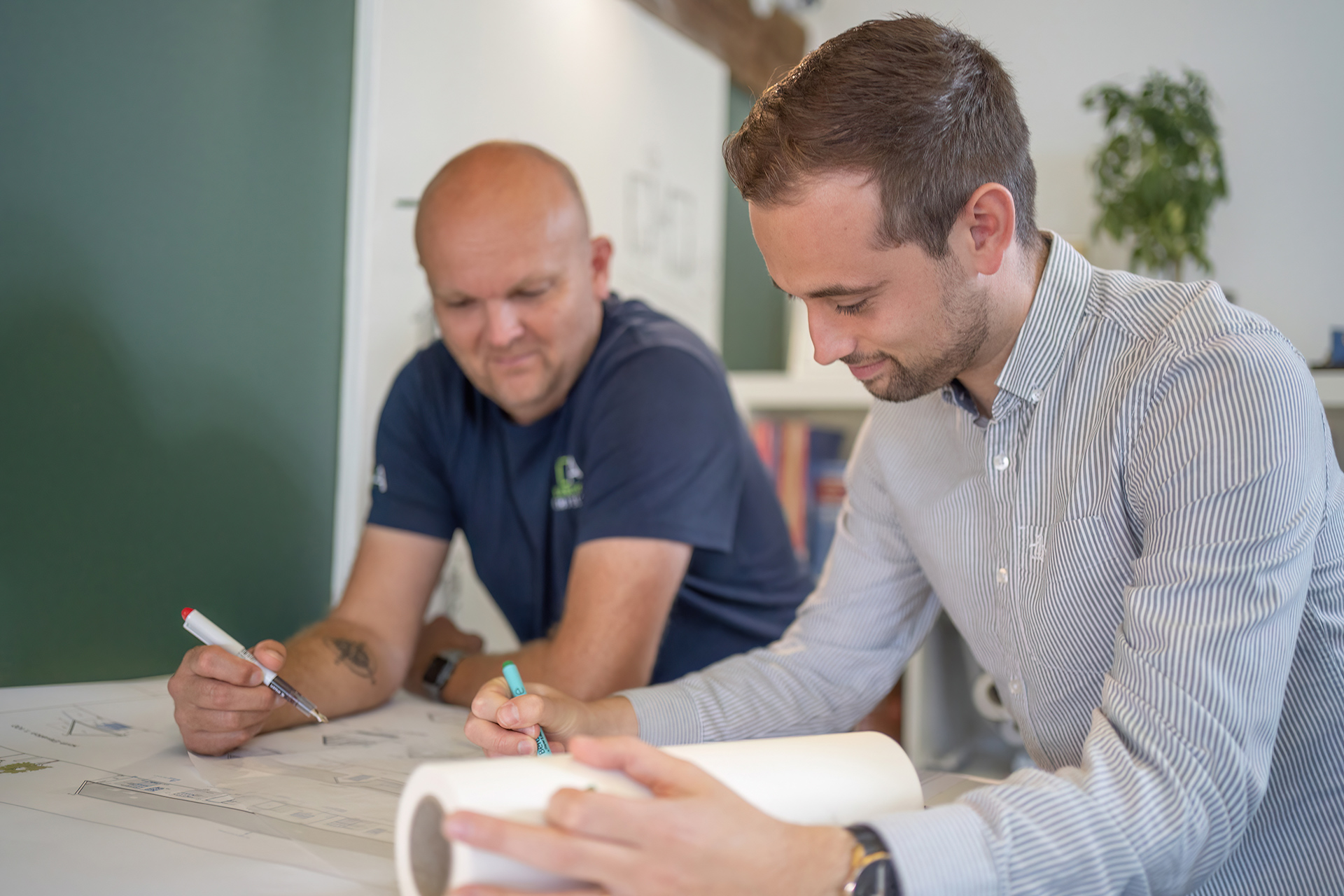 Two men discussing a drawing