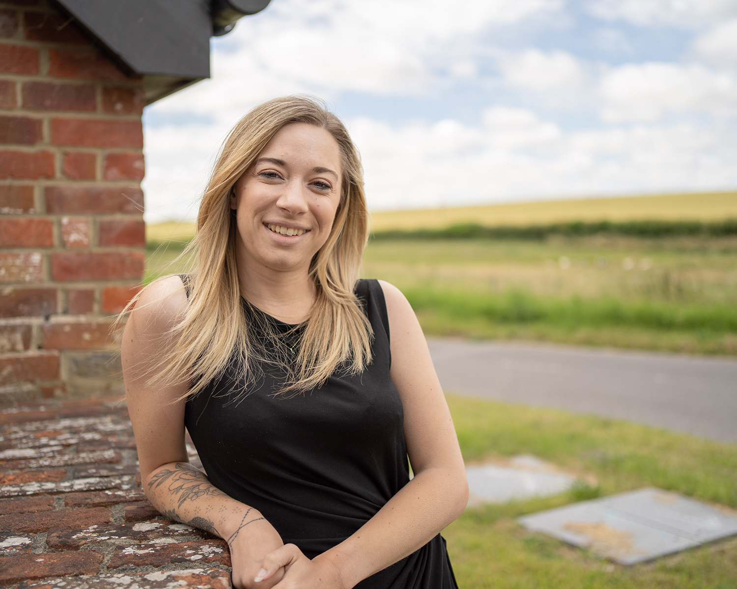 Lucy Park, woman leaning against wall smiling