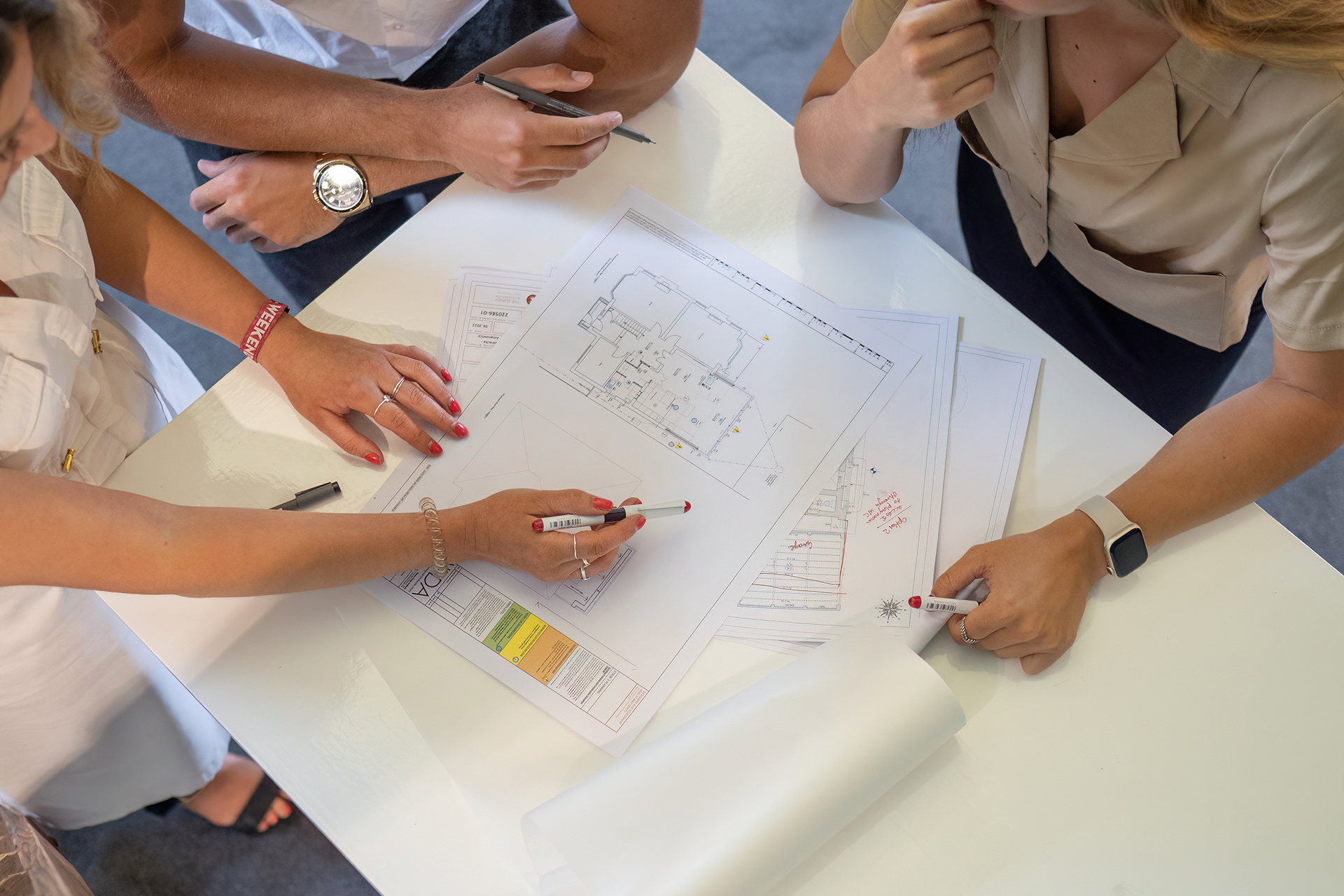 People discussing a drawing at table