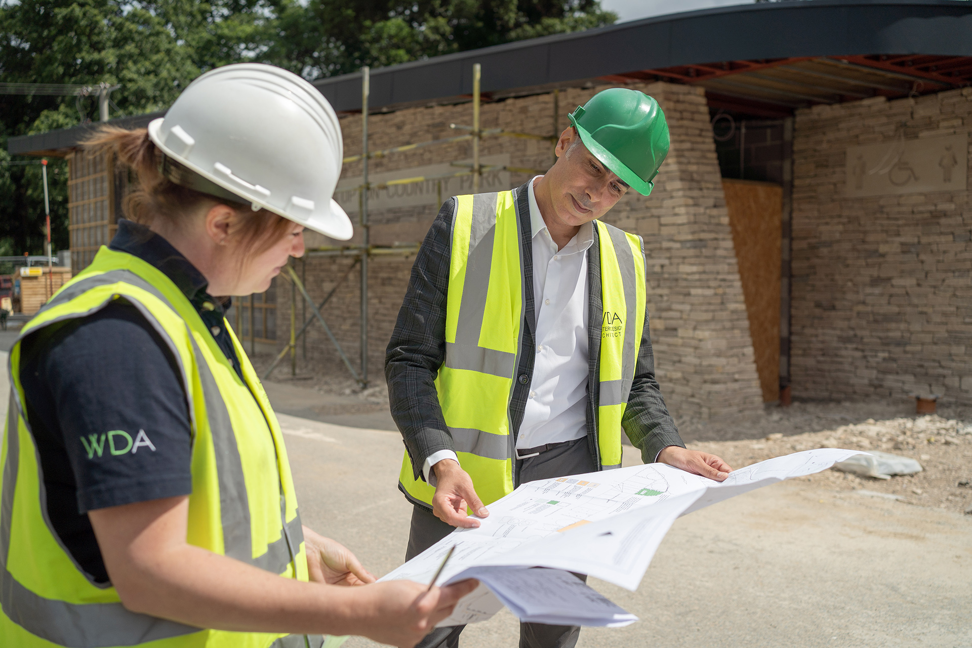 Becky and Matt looking at a drawing on a site meeting