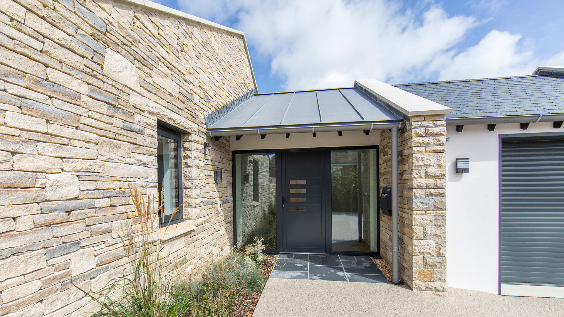 entrance porch with stone wall and planting