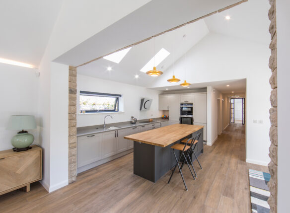 white kitchen with vaulted celing