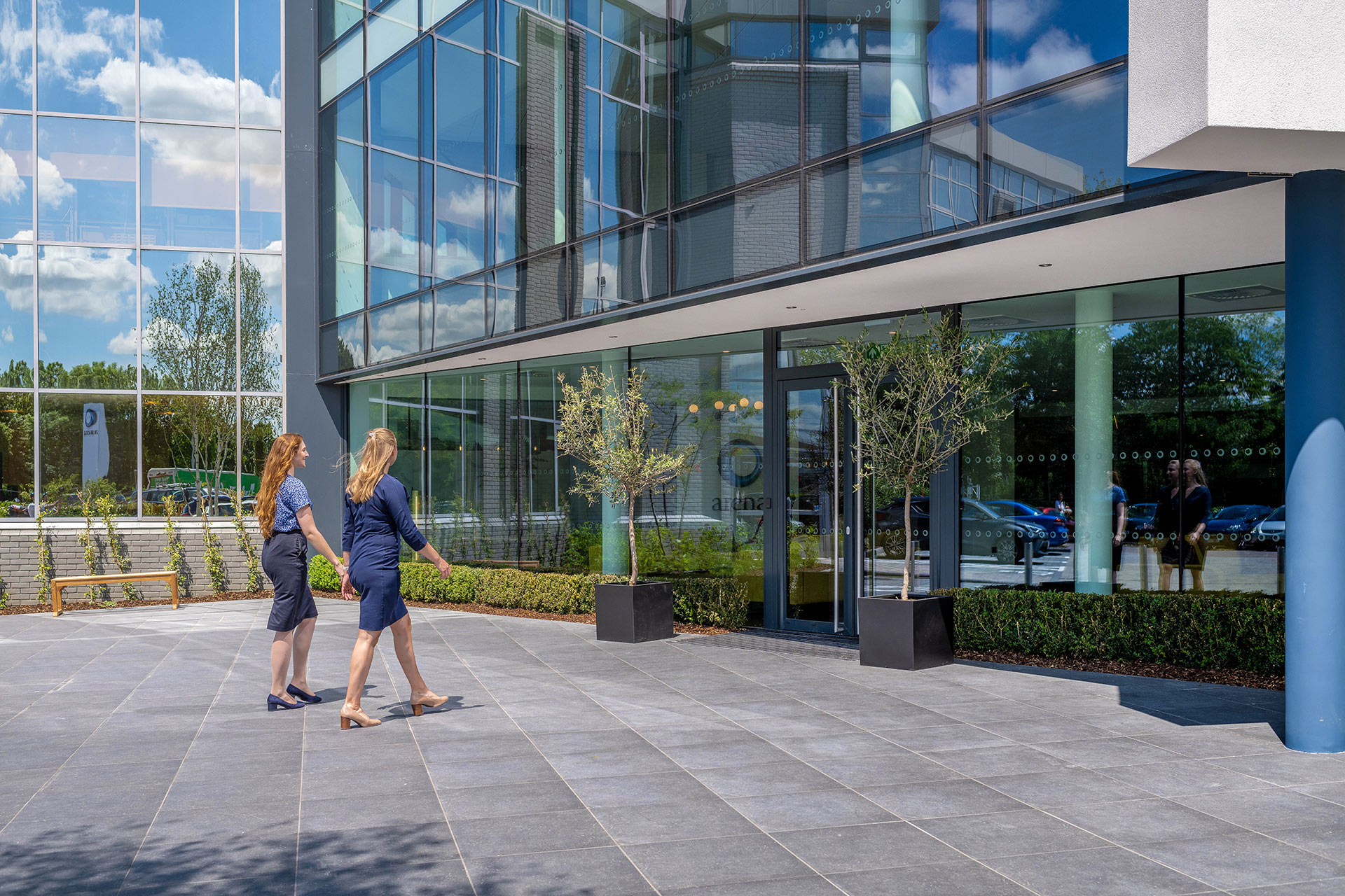 people walking into glazed entrance area of office