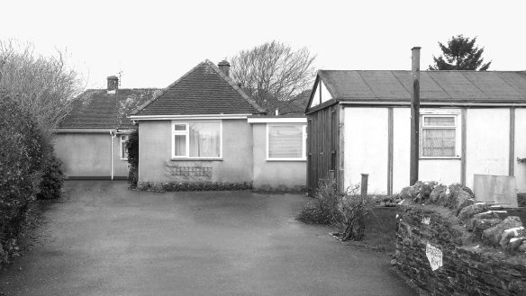 before photo of bungalow with driveway in front