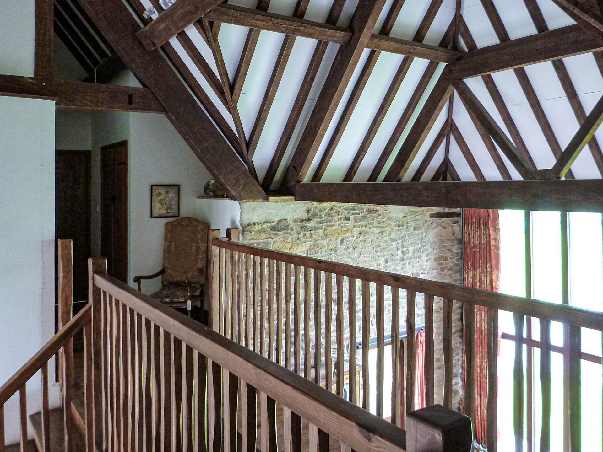 Vaulted ceiling with exposed timber beams and trusses and gallery landing