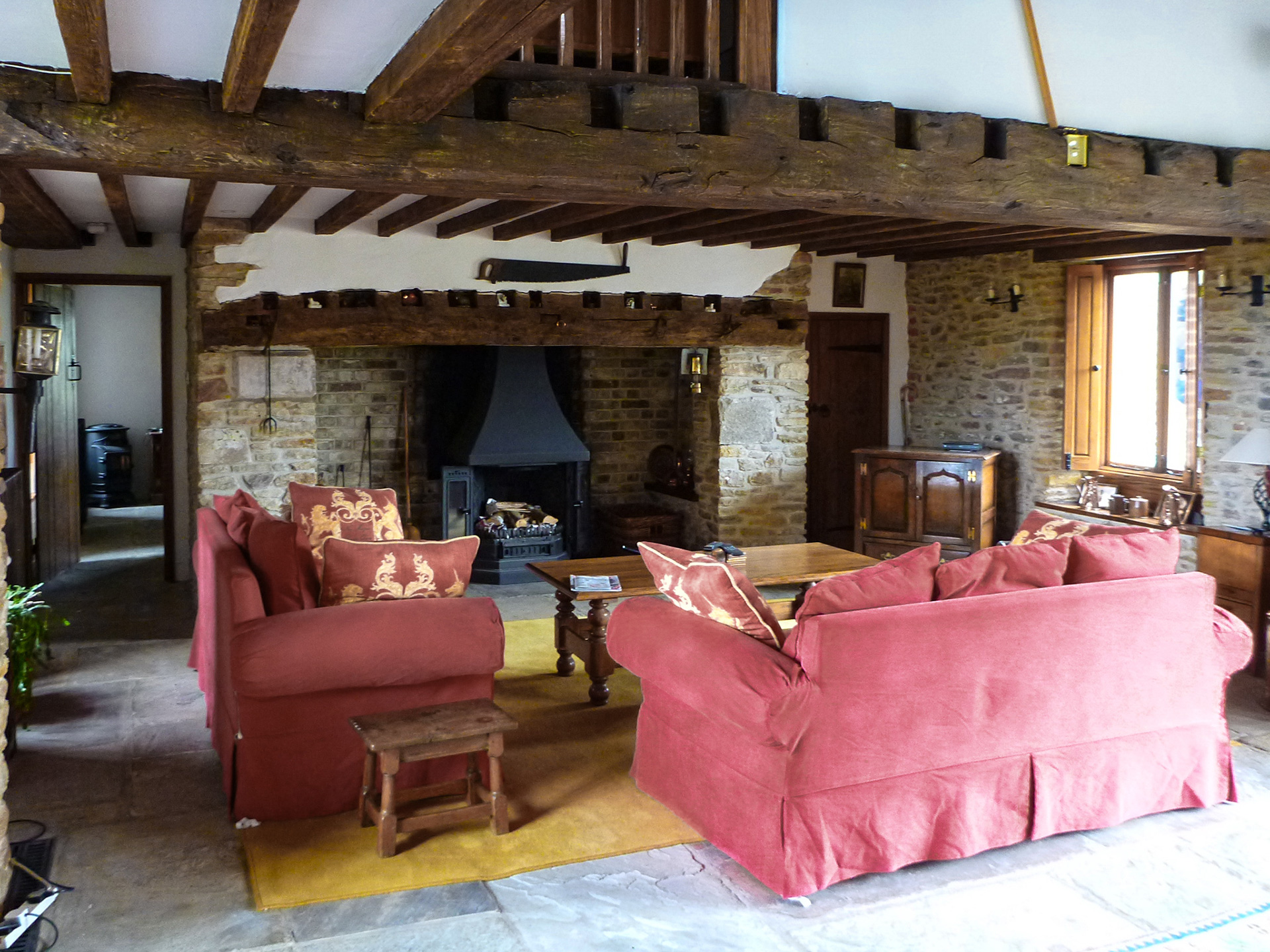 fireplace in rebuilt barn with exposed beams