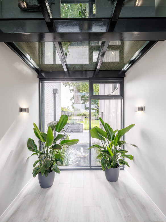 modern entrance hall with plants and glass ceiling