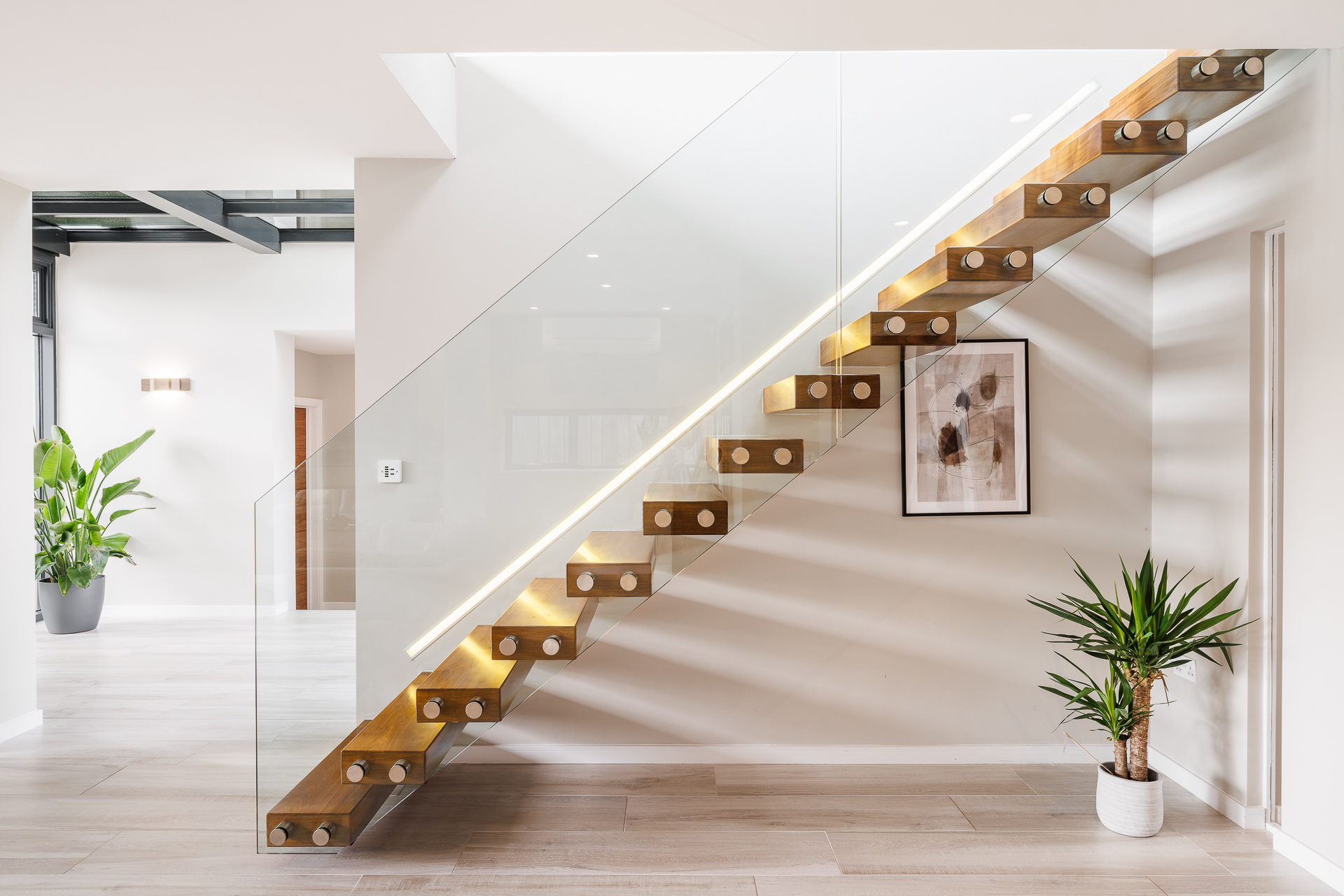 attractive contemporary floating staircase with glass side panel