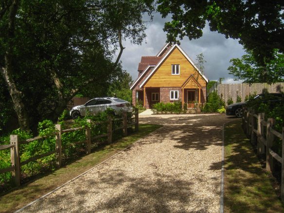 new timber clad house at end of a gravel lane