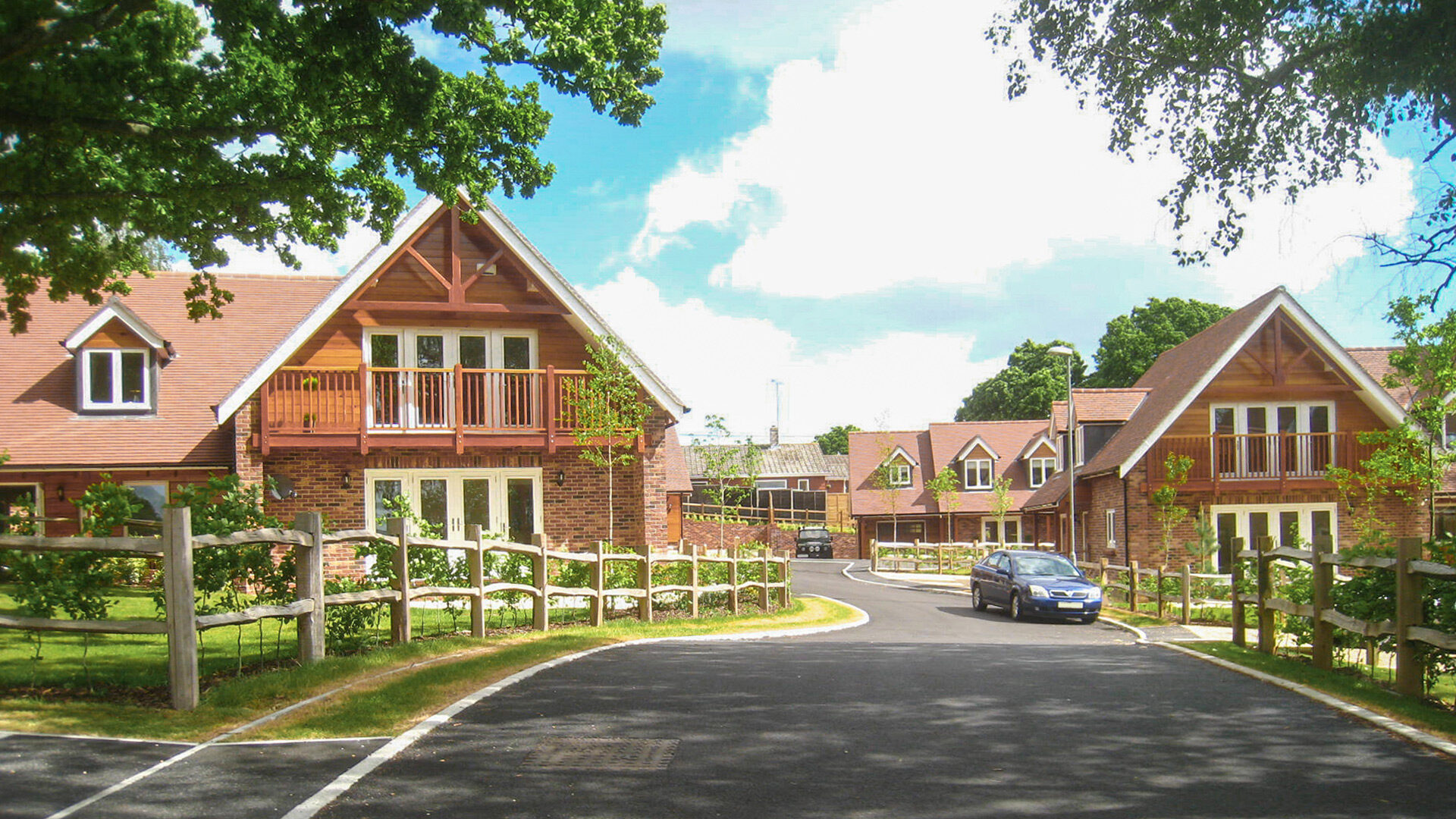 road with timber clad chalet bungalows and trees