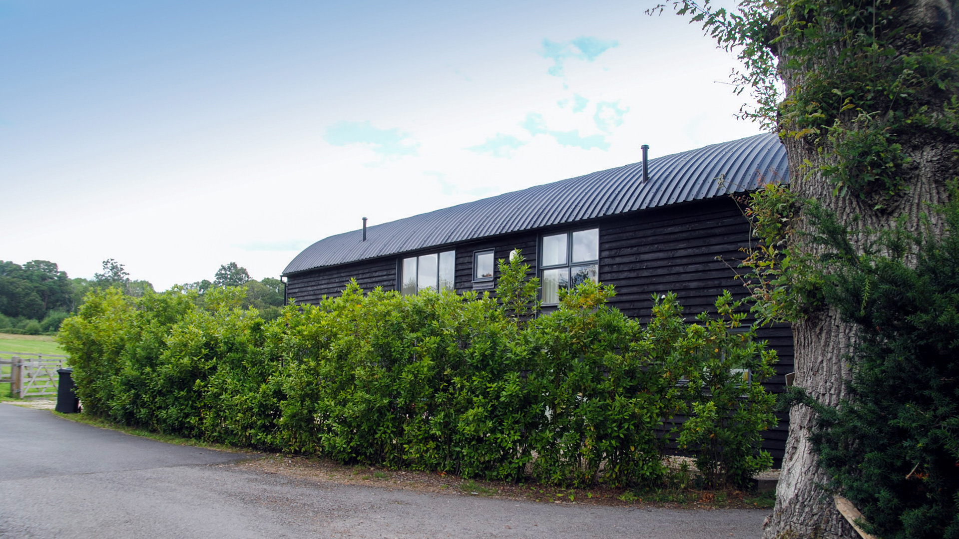 side view of finished black barn conversion