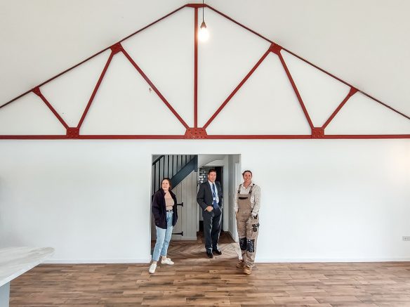 Interior of converted barn with exposed original roof truss