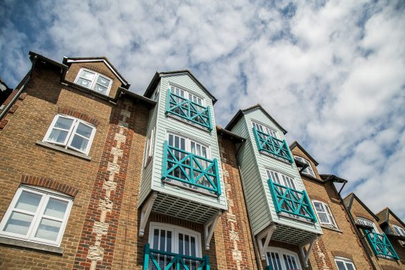 brick apartment building with overhanging windows