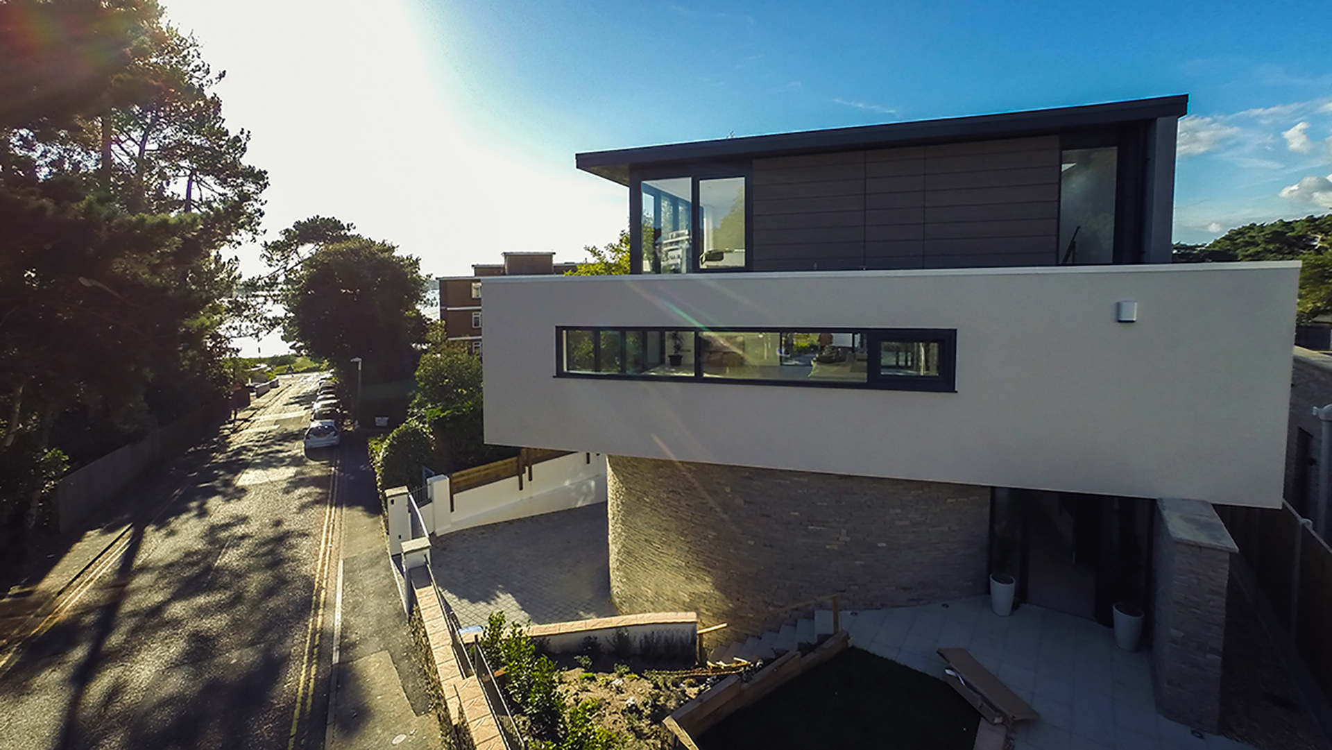 side view of modern home with large glass windows and sea views