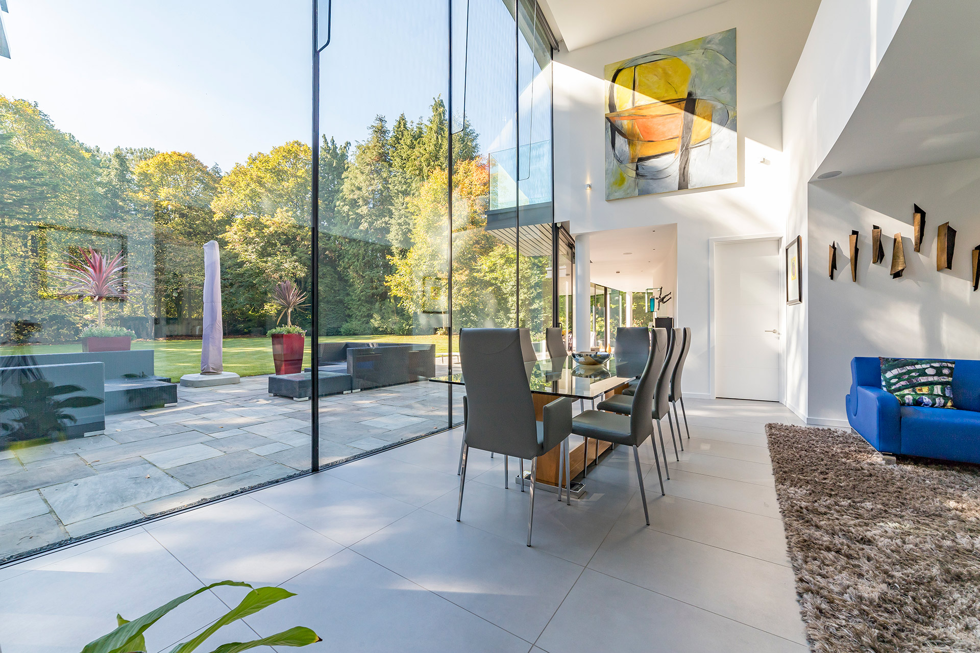 dining table next to double height glazing