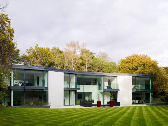 view from rear garden of modern house with large glass windows