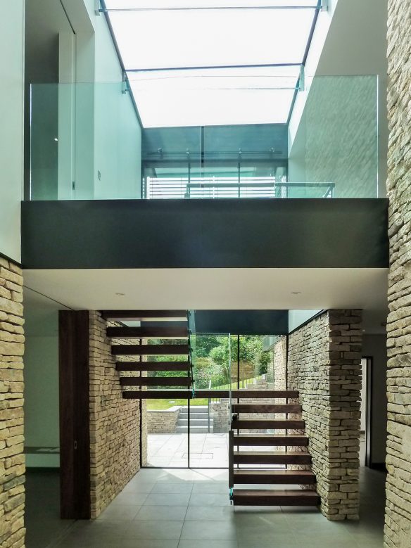 dog leg floating staircase in modern house with exposed brickwork