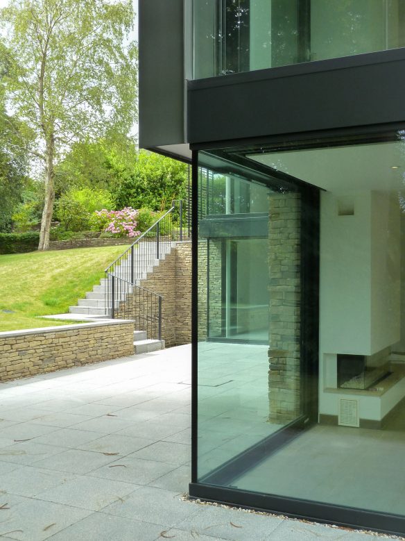 corner window of home with sloping garden in background