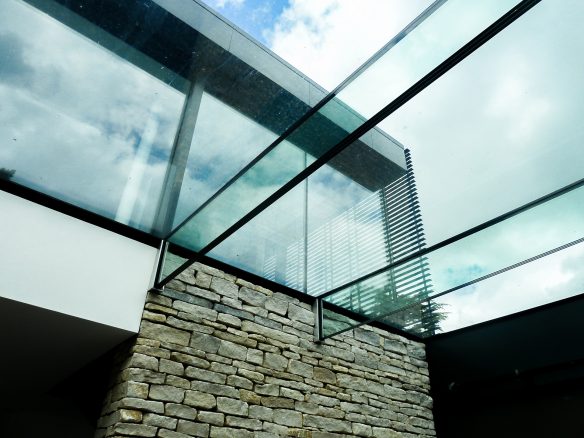 glass roof in home with exposed brick wall