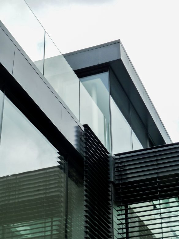 intersection detail on building with glass balcony