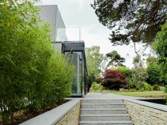 steps leading up to modern house with large garden