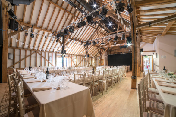 interior of hall with exposed beams and set up for a wedding
