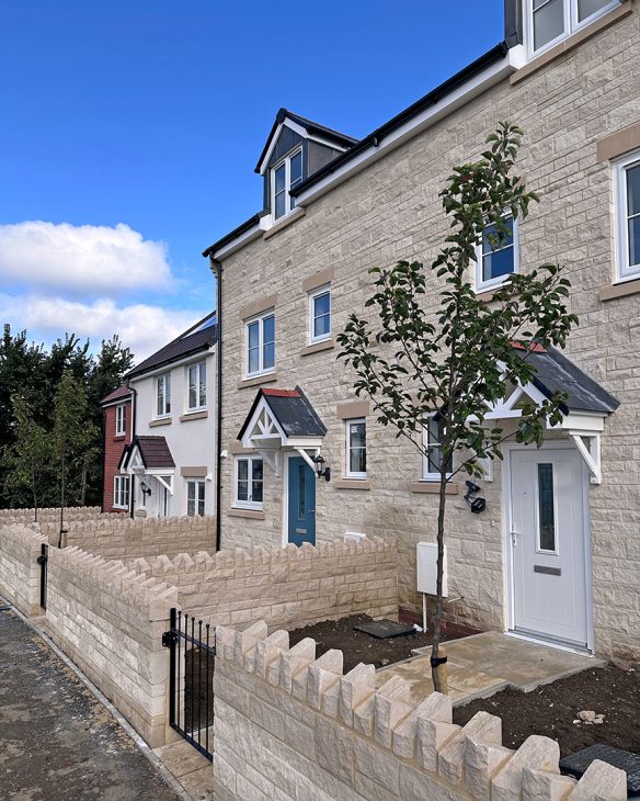 Terraced stone houses with enclosed front garden areas
