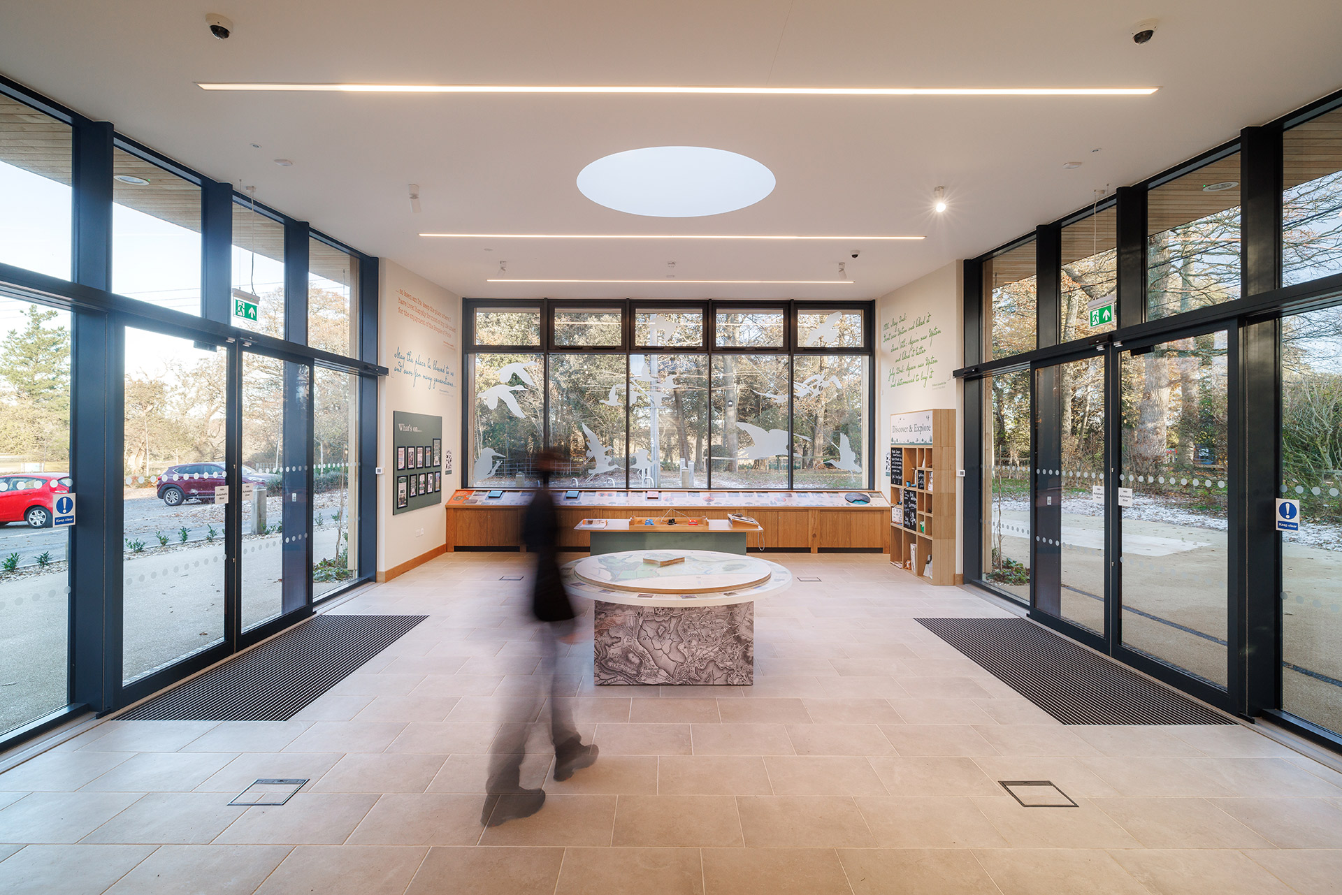 internal photo of information centre with glass automatic doors and windows on all walls