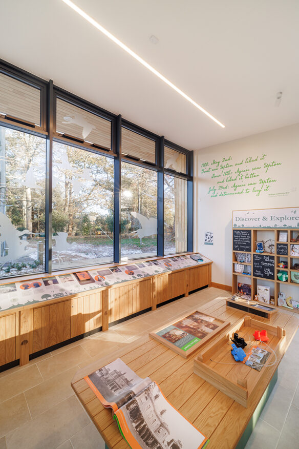 internal photo of welcome centre with large windows looking out onto woodland