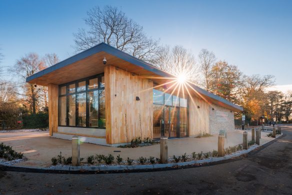 front and side view of welcome centre with sun setting over roof