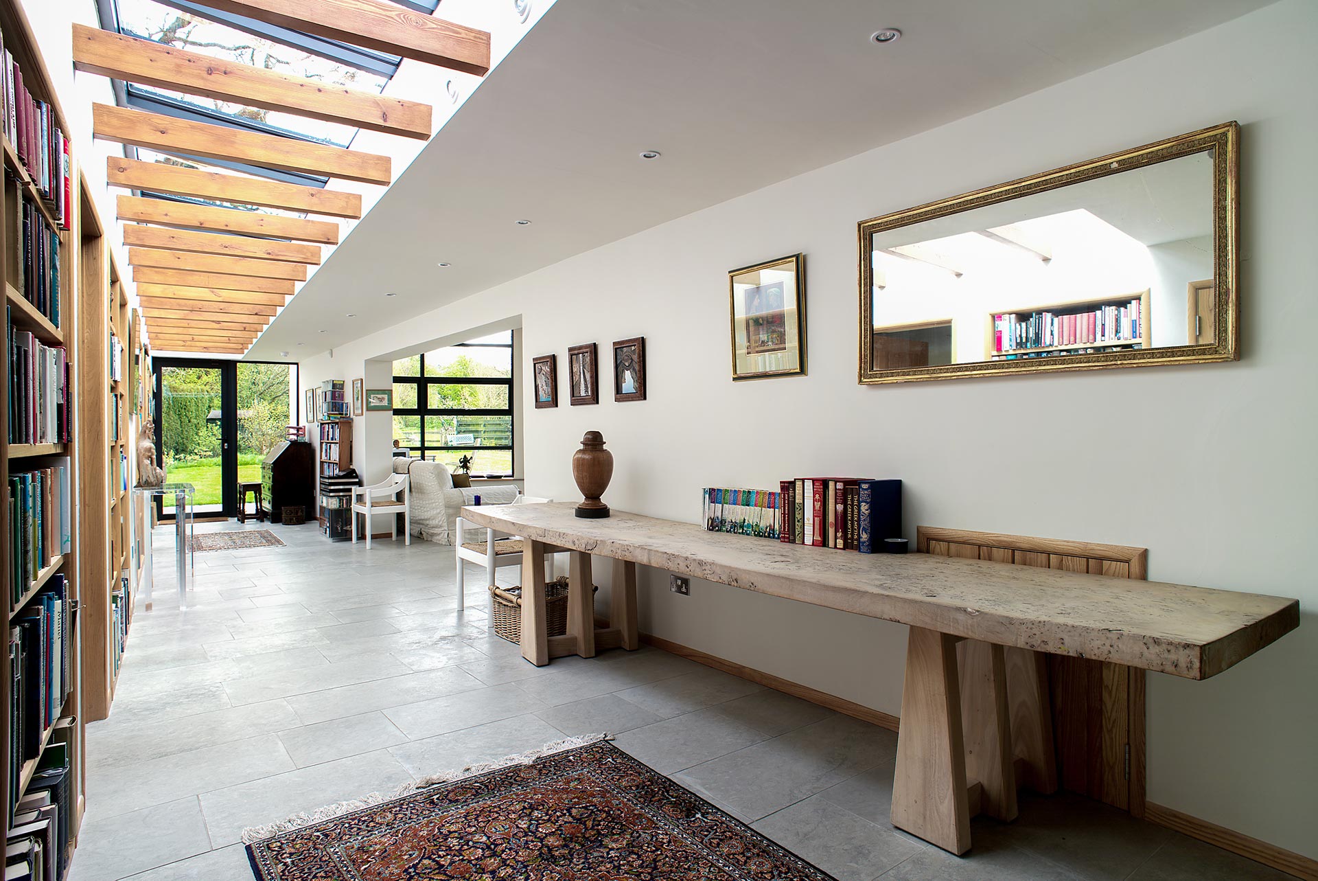 stunning interior hallway view with skylights and exposed beams