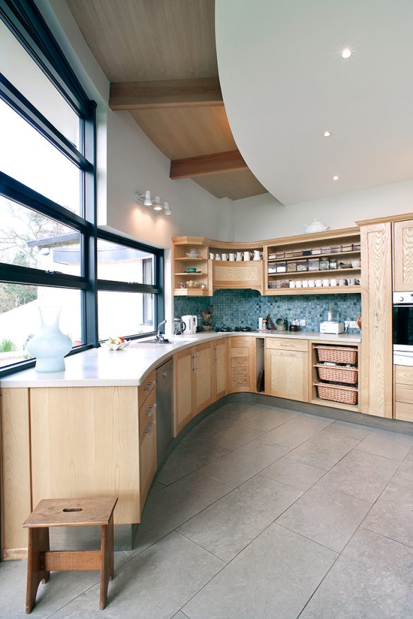 interior of large kitchen with curved wall and windows