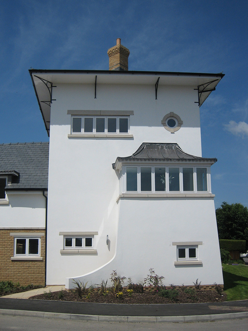 front view of corner white house with large windows