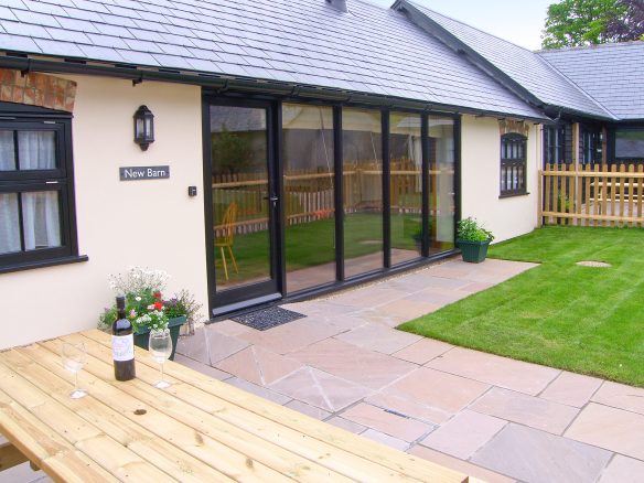 New barn conversion with full length windows leading to patio