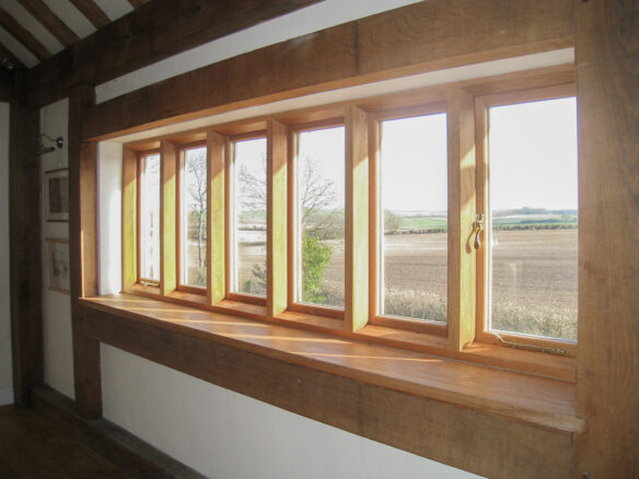 interior view of wooden windows overlooking a beautiful countryside view