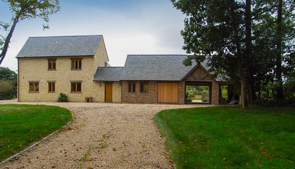 front view of stone and red brick house from driveway