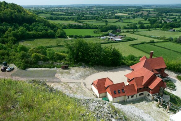 aerial view of large residential house with red tiles and lovely countryside views in distance
